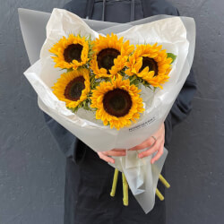 Букет Теплое лето в букете: 5 подсолнухов в упаковке с аквабоксом и переноской Букет Теплое лето в букете: 5 подсолнухов в упаковке с аквабоксом и переноской